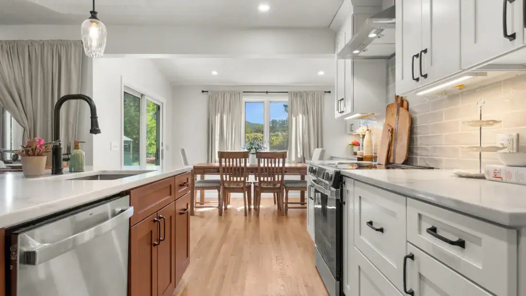 View along the white oak island toward the connected dining area in the renovated Pittsfield kitchen.